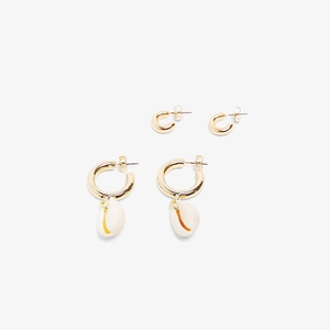 Detail of golden hoop earrings and shell pendant set for bohemian summer beach jewelry style
