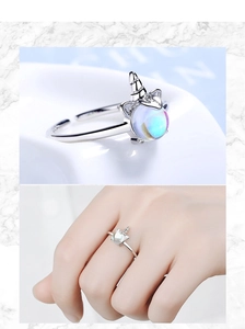 Macro detail of silver unicorn ring featuring iridescent moonstone and pavé crystal accents