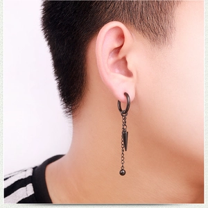 Detail of men's black stainless steel hoop earring with punk tassel chain and spike pendant