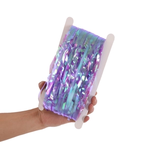 Hand holding a roll of purple iridescent foil fringe curtain for party backdrop decoration