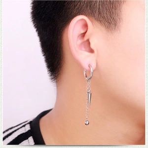 Detail of silver chain earring with cone spike and polished ball charm for men