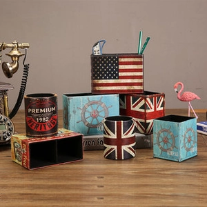 Close-up of vintage metal organizers with retro flag patterns and nautical compass designs