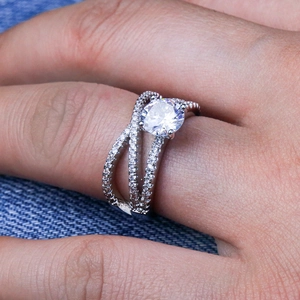Sparkling silver cross-wrapped engagement ring with large central round zircon stone