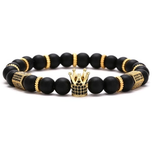 Close-up of black matte beads with gold crown charm and inlaid crystals for a retro look