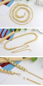 Detailed view of gold metal belt with woven pearls and adjustable lobster clasp