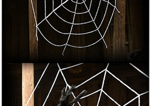 Close-up of a large white triangular spider web decoration for Halloween party scenes