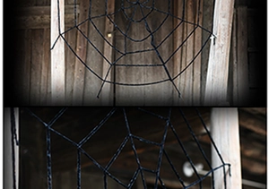 Close-up of a large black triangular spider web decoration for Halloween party setup