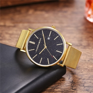 Men's gold quartz watch with black starry sky dial and mesh steel strap on a display stand