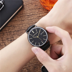 Men's business quartz watch with starry sky dial and black leather strap on wooden desk
