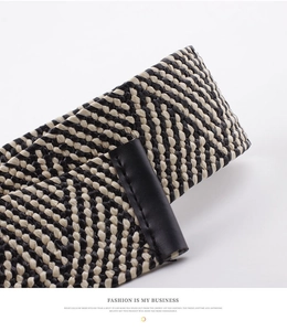 Macro shot of high-density woven belt texture with black matte leather fastener detail