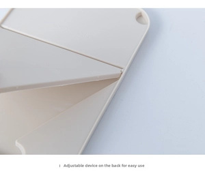 Close-up of the adjustable folding hinge on a beige portable desktop makeup mirror