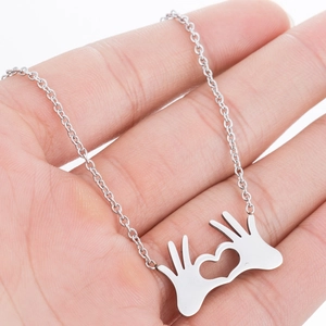 Polished stainless steel necklace featuring a unique hands forming heart gesture pendant