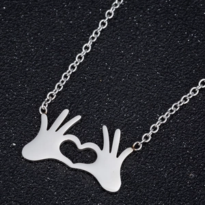 Polished stainless steel necklace featuring a creative OK hand gesture heart pendant