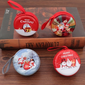 Close-up of Christmas tinplate coin purses with lanyards on vintage books