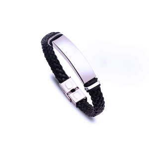 Detail of hand-woven black leather bracelet with blank silver stainless steel plate