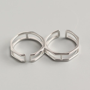 Macro shot of two silver geometric hollow S925 sterling silver open adjustable rings