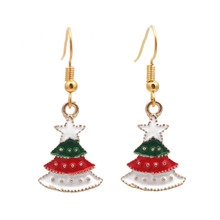 Close-up of enamel Christmas tree earrings with festive red and green layered colors