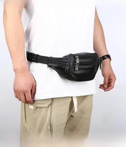 Close-up of black litchi grain leather fanny pack with three zipper pockets and buckle strap
