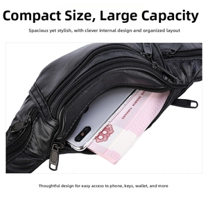 Top view of black leather waist bag showing multi-layer zippers and spacious main compartment