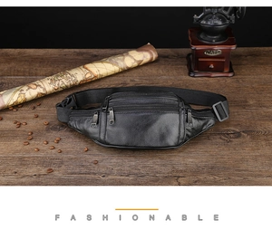 Detail of vintage black waterproof leather waist bag with multi-zipper pockets on wood