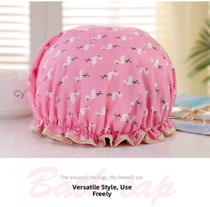Pink waterproof shower cap with white flamingo prints and a golden silk elastic edge