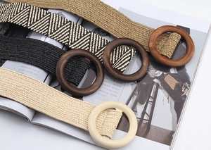 Detail of bohemian woven elastic belts with natural round wooden buckles in various colors