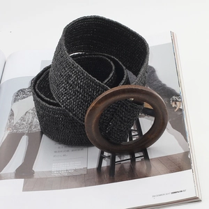 Detail of bohemian woven belt with a round wooden buckle on a fashion magazine