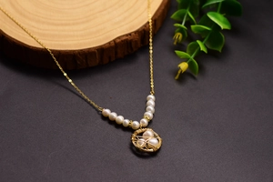 Macro detail of bird nest pendant with pearls on golden chain and natural wood background