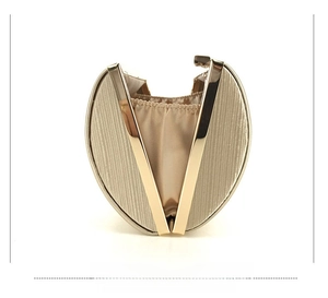 Side view of light gold evening clutch bag with vertical texture and metal frame
