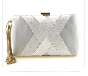 Silver woven satin evening clutch bag featuring a metallic push lock and long gold tassels