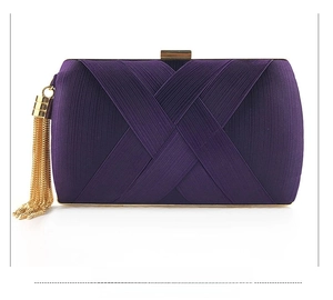 Detailed front view of purple satin clutch bag featuring elegant gold metal fringe