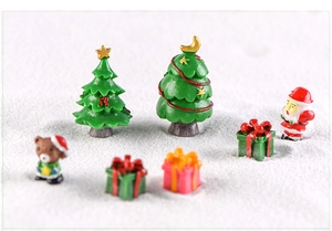 Miniature Christmas resin set with trees and figures on artificial snow background