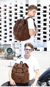 Detail of vintage brown canvas backpack with leather straps and large side pockets