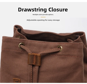 Detail of canvas backpack with drawstring closure and bronze metal eyelets