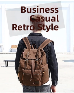 Outdoor shot of deep brown canvas backpack with leather straps and vintage workwear design