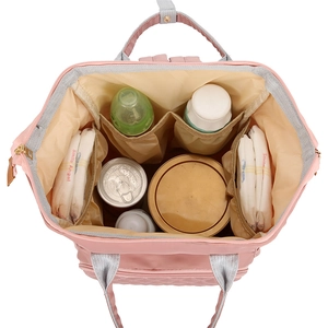 Pink nylon diaper backpack with large cream interior capacity and multiple compartments