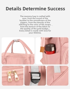 Detail of pink waterproof nylon diaper bag showing texture, zippers, and side pockets