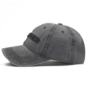 Detail of 3D embroidered logo on washed cotton canvas baseball cap with vintage texture