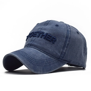 Close-up of 3D embroidered TOGETHER text on washed navy cotton baseball cap