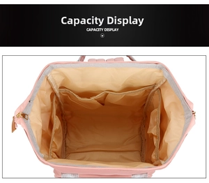 Detailed capacity display of the pink nylon diaper bag showing internal storage compartments