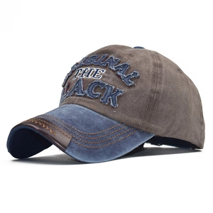 Detailed embroidery on vintage washed denim baseball cap with leather brim edge