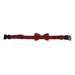 Detail view of pet bow tie collar with red and black plaid pattern and plastic buckle