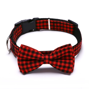 Detail of red and black buffalo plaid pet collar with bowknot and durable metal D-ring