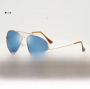Close-up of classic pilot sunglasses with golden metal frames and blue mirrored lenses