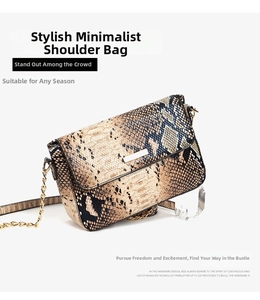 Close-up of snakeskin pattern faux leather bag with elegant gold chain and metal plaque