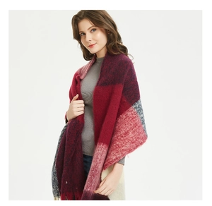 Detailed view of thick tassel edges on a soft oversized plaid scarf shawl for women