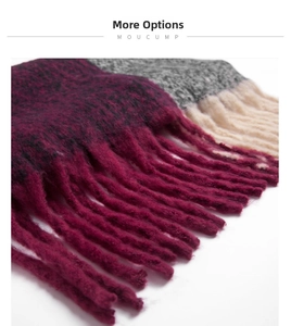Detail shot of the chunky tassels and thick woven texture on a burgundy and grey scarf