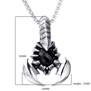 Macro detail of silver scorpion pendant with black gemstone and size dimensions