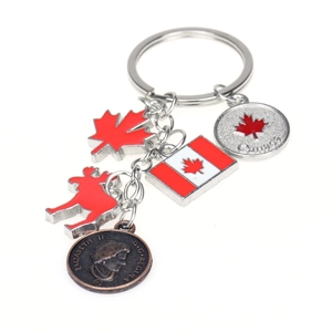 Canada flag keychain with maple leaf, moose, and Elizabeth II coin charms on white background