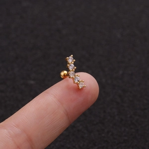 Detail of a tiny gold screw-back cartilage earring with five zircon stones on fingertips
